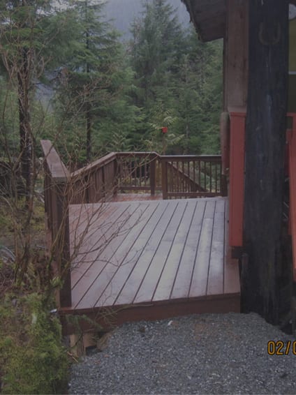 A wooden deck with trees in the background