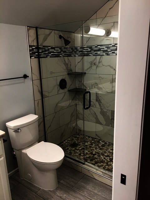 A bathroom with a toilet and shower in it